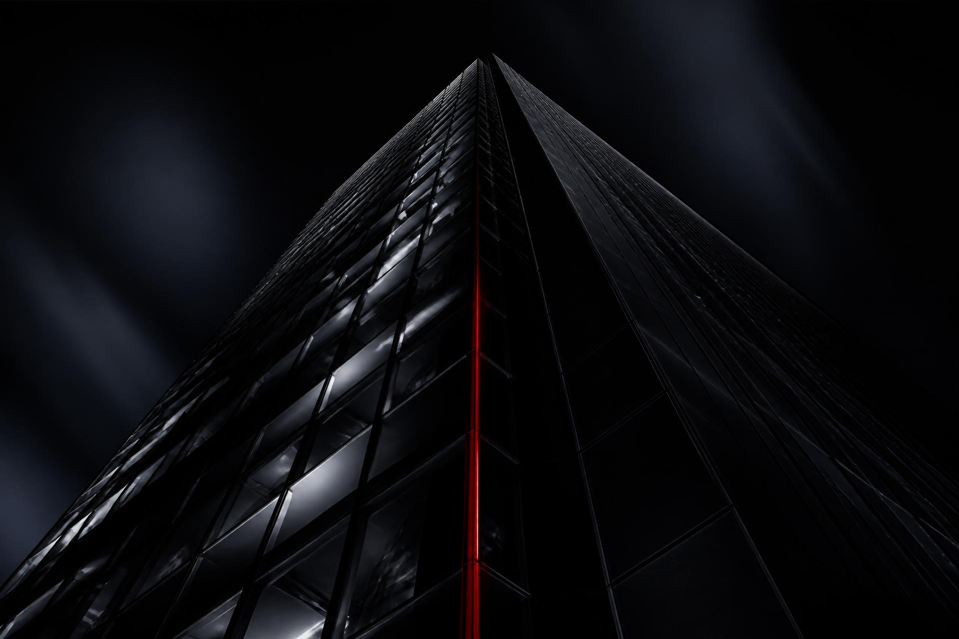 Black glass tower rising into the night